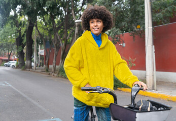 man afro mexican is on a rented bike with a look of contemplation on the streets of Mexico City