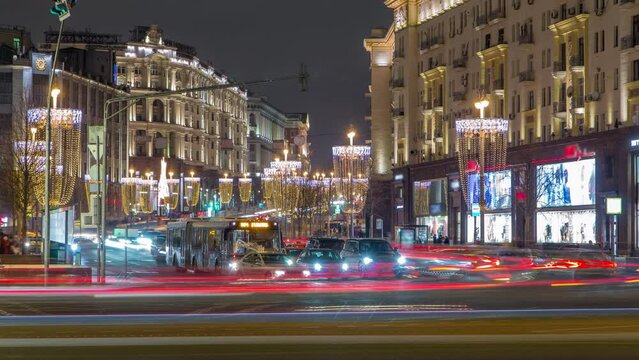 Timelapse of the festive Tverskaya Street with wineglass-shaped street lamps on a frosty winter night, featuring traffic and the view from Manezhnaya square. Moscow, Russia.