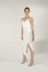 Fototapeta premium Serie of studio photos of female model in elegant white dress 