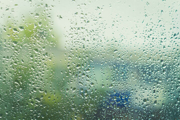 Drops on glass after rain. Autumn weather outside window. Rain outside window.