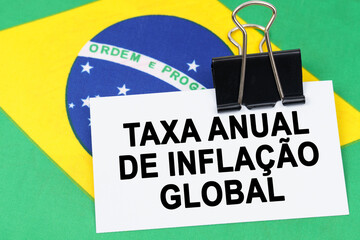 On the flag of Brazil lies a business card with the inscription - Annual headline inflation rate