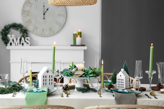 Festive table setting in living room with fireplace and Christmas decor - Powered by Adobe