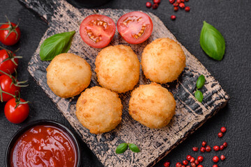 Delicious round balls of mozzarella and parmesan cheese with salt and breaded spices