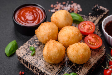Delicious round balls of mozzarella and parmesan cheese with salt and breaded spices