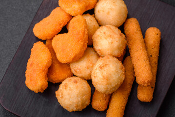 Delicious nuggets, sticks and balls of mozzarella and parmesan cheese with salt and spices