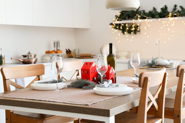 Beautiful table setting with Christmas decorations in festive kitchen