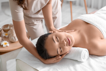 Fototapeta na wymiar Young woman having massage in spa salon, closeup