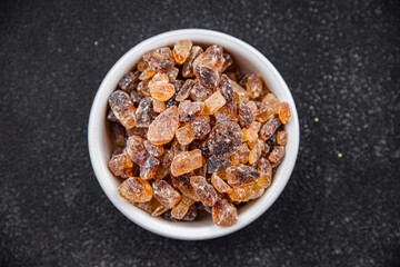 Obraz na płótnie Canvas rock sugar crystals pieces candy brown sugar candied big rock caramel taste cane sugar healthy eating cooking appetizer meal food snack on the table