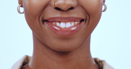 Black woman, face and lip gloss with kiss for makeup, beauty product or wellness routine in studio on blue background. Cosmetics, person and lipstick for self care, closeup and shiny lips with smile - Powered by Adobe
