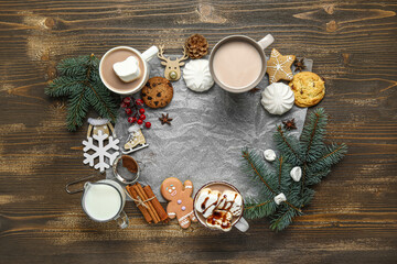 Frame made of tasty Christmas cocoa with marshmallows, cookies, milk, snowflake, cinnamon and pine cone on wooden background