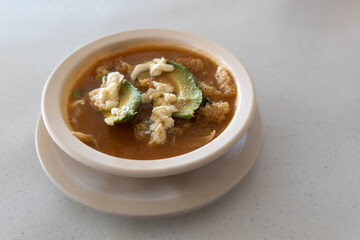 Mexican aztec soup with chicharron avocado cheese and tortilla