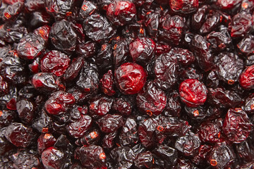 Dried cranberries texture food background. Heap of red autumn berries closeup