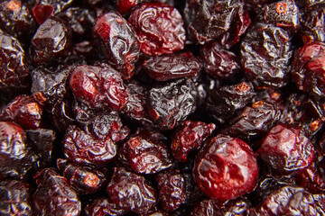 Dried cranberries texture food background. Heap of red autumn berries closeup