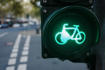 Selective focus at green traffic light with bicycle sign over bicycle lane.  - obrazy, fototapety, plakaty