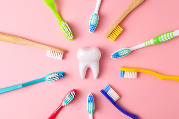 Different toothbrushes on a colored background. Dental care, oral health.