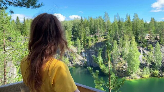 Happy young woman background Marble canyon in Ruskeala, Karelia