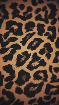 Vertical video - simple leopard print motion background. This animal print background animation is full HD and a seamless loop.	
