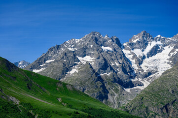 Fototapeta na wymiar Mountains and alpine meadows views near Col du Lautaret, Massif des Ecrins, Hautes Alpes, France in summer