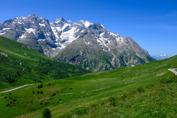 Fototapeta na wymiar Mountains and alpine meadows views near Col du Lautaret, Massif des Ecrins, Hautes Alpes, France in summer