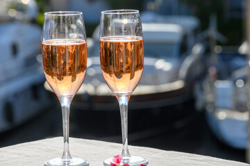 Summer party, drinking of French brut rose champagne sparkling wine in glasses in yacht harbour of Port Grimaud near Saint-Tropez, French Riviera vacation, France