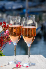 Summer party, drinking of French brut rose champagne sparkling wine in glasses in yacht harbour of Port Grimaud near Saint-Tropez, French Riviera vacation, France