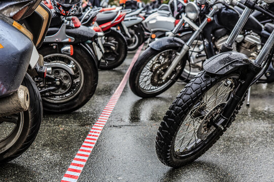 motorcycles on the paved parking lot in the rain