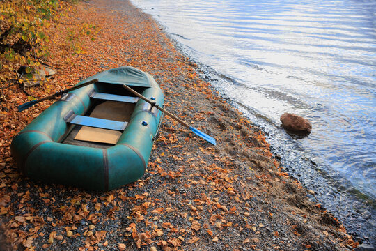 Rubber boat on the river bank in autumn