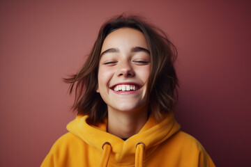 Portrait of happy girl in color clothing on color background 