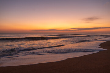 Fototapeta na wymiar Sunrise on Florida beach, reflections on the sand