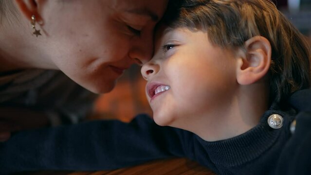Cute affectionate moment between mother and child doing eskimo kiss, facing nose to nose