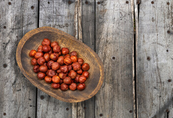 Corylus avellana - Hazelnut nuts in the wooden bowl