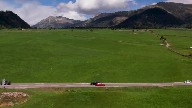 areal footage of car driving up to mountain in sunny day Italy apls