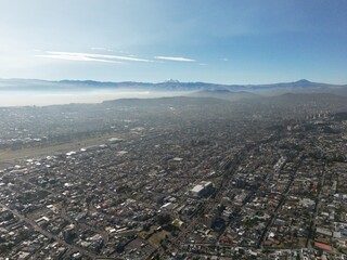 Aerial shot of Quito early in the morning, where you can see lots of volcanos.  