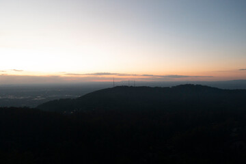 Twilight TV Towers Standing Tall Atop a Mountain Against the Dusky Sky