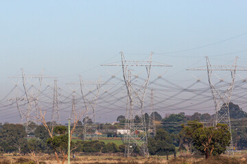 Power Line Poles Against Distant Horizon of Air Pollution