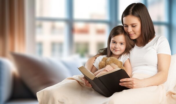 Portrait of young mother reading book to child, AI generated image