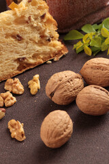 Nuts on the table, one in the foreground and three in the background, panettone background