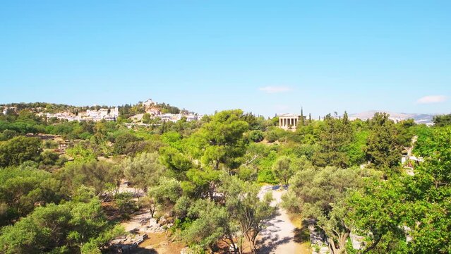 Ancient agora ruins buildings old archeological site near Acropolis, Athens Greece by temple of Hephaestus wide angle panning shot in summer