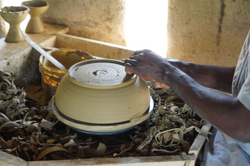 Hand of person making clay pot