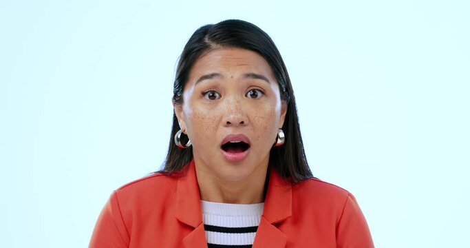 Woman, face and shocked or surprised by news, gossip and drama in studio by blue background. Asian person, portrait and huh for secret announcement, mind blown and did you know or wtf in mockup