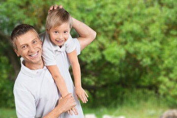 Fototapeta premium Playful father spending time with son in park