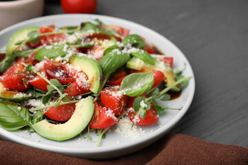 Tasty salad with balsamic vinegar on grey wooden table, closeup