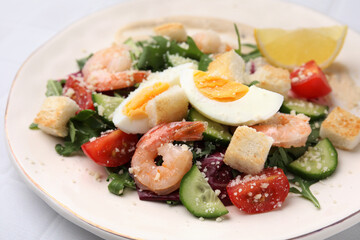 Delicious Caesar salad with shrimps on white table, closeup