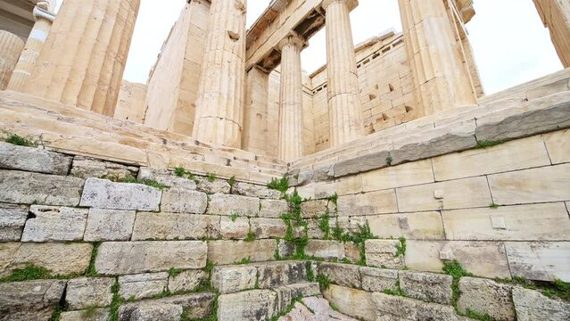 Propylaea propylaia gate gateway temple, Acropolis ruins building, Athens Greece wide angle view panning shot, looking up marble columns against sky