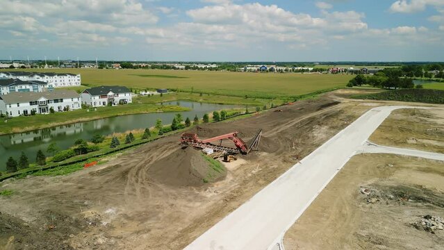 Wide Drone shot of suburb in pre construction empty lots and home