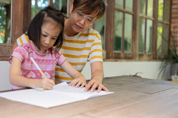 A beautiful moment of family connection and learning. A mother and her adorable daughter are...