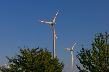 A wind generator stands in the Netherlands on a sunny summer day. Ecology, green energy and saving...