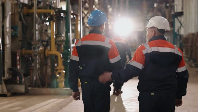 Engineers inspect, Engineers circle, Machinery check. Engineers patrol the facility's premises.