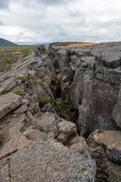 Grjotagja lava cave and fissure in Myvatn, Iceland under autumn afternoon cloudscape.