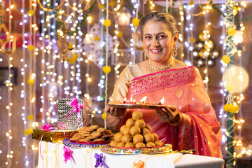 Senior woman Diwali Celebrate at home.